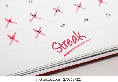Calendar with several pink X marks and the word 